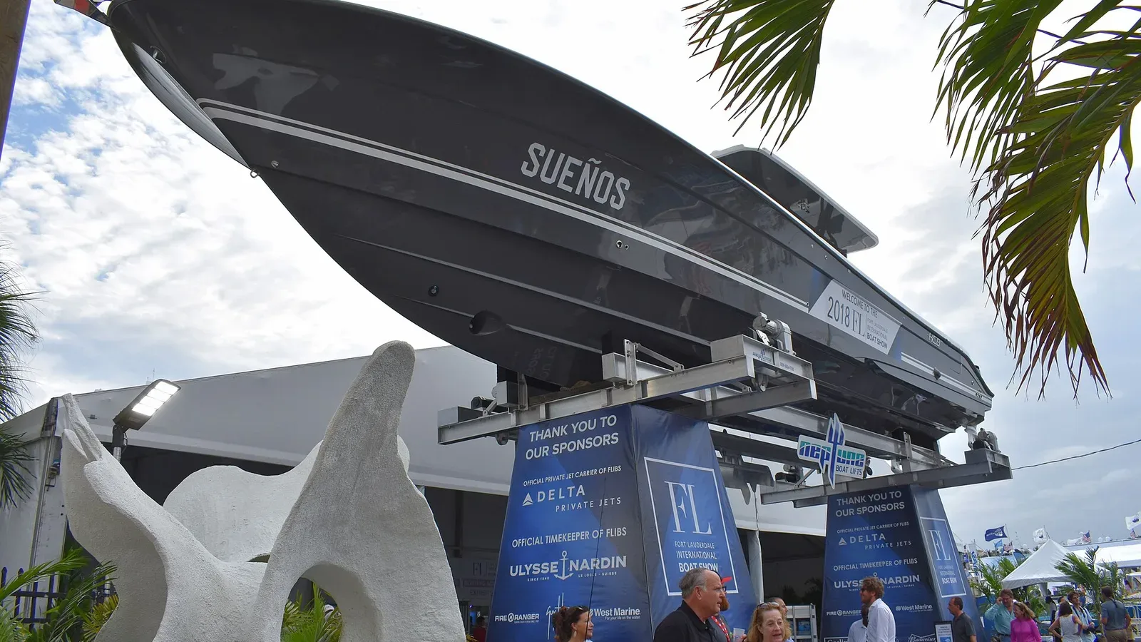 A centre-console powerboat raised on a lift above the entrance to the 2018 Fort Lauderdale International Boat Show