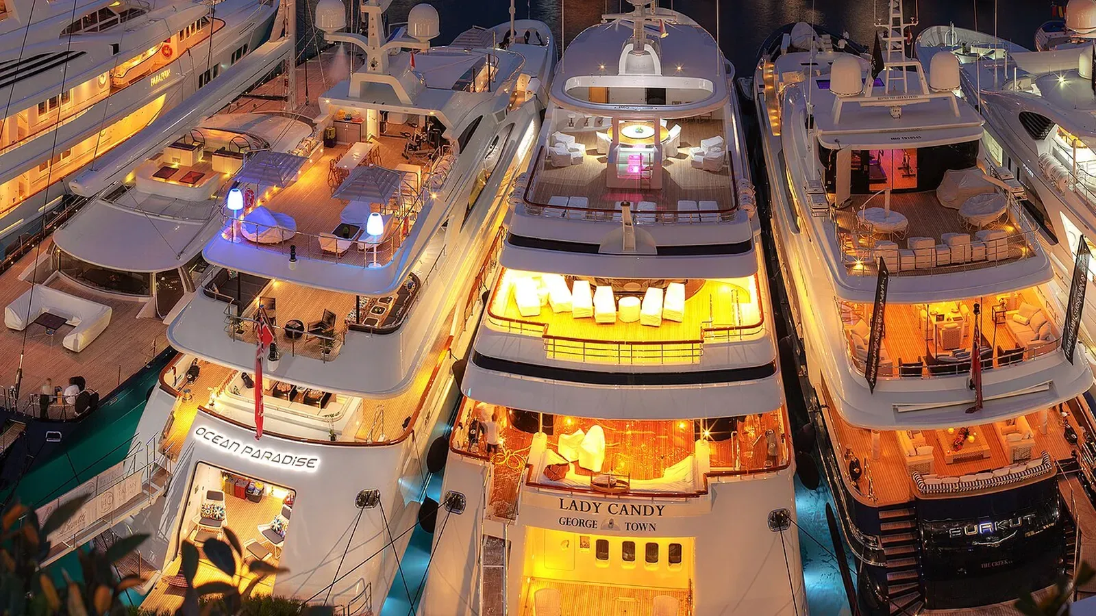 Superyachts lit up at dusk in Port Hercule during the 2013 Monaco Yacht Show