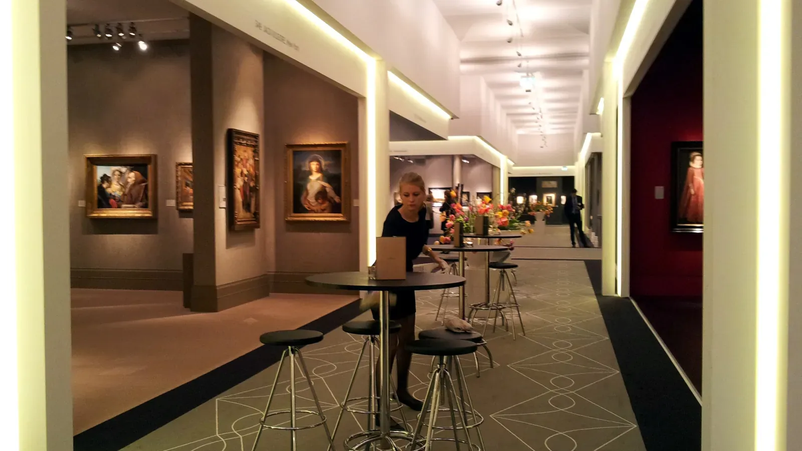 Old Master paintings on dealers' stands along an aisle at TEFAF Maastricht 2014