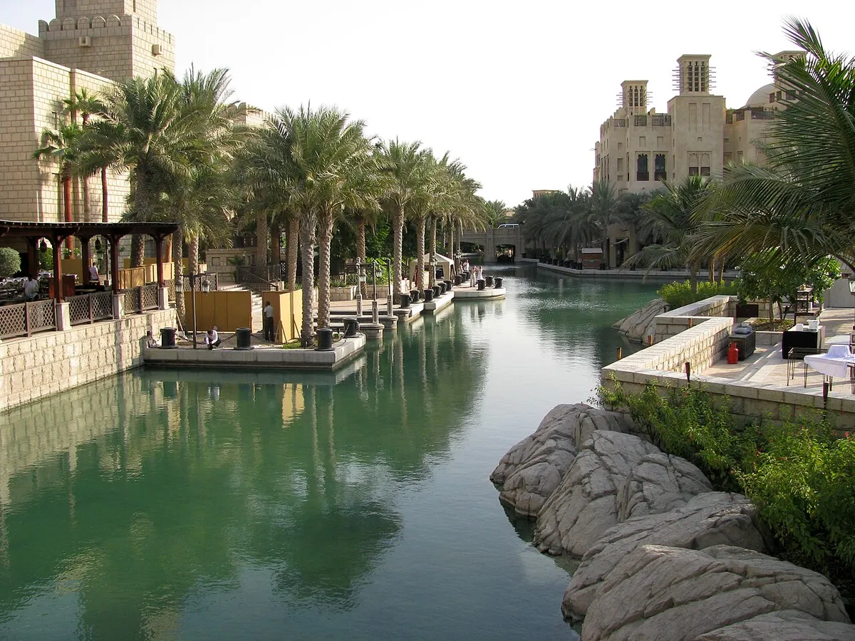 A palm-lined canal running between buildings in the Madinat Jumeirah resort