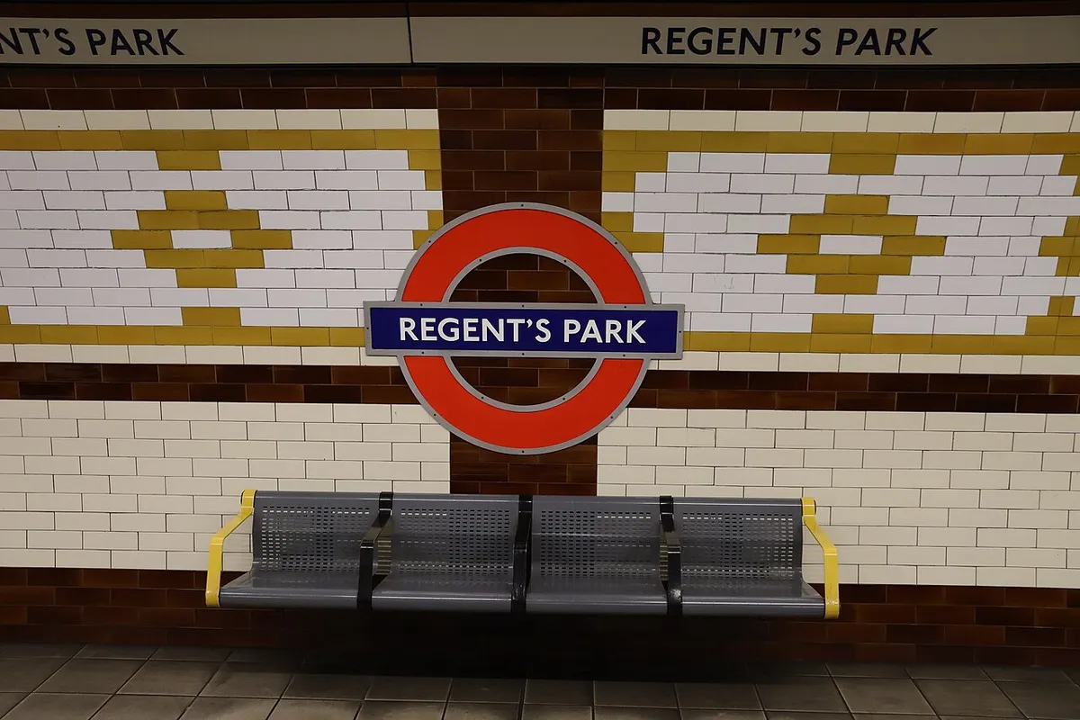 The Underground roundel sign reading Regent's Park on a tiled station platform wall