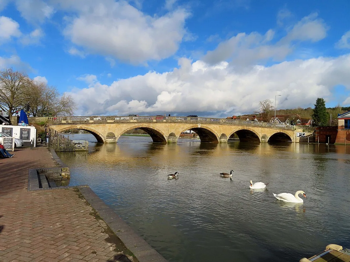 The five-arched stone Henley Bridge over the Thames, with swans on the water