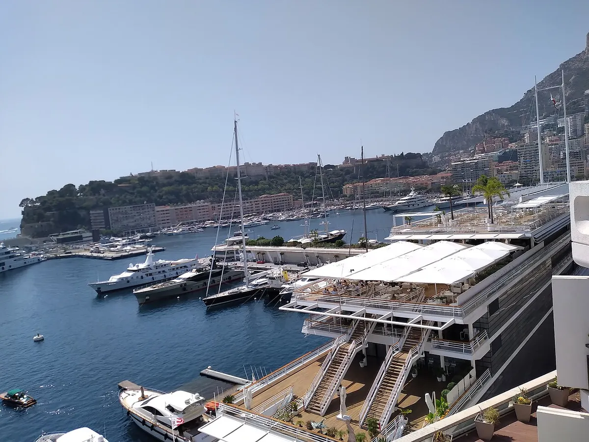 Port Hercule's marina with yachts moored below Monaco's apartment buildings and the Yacht Club terraces