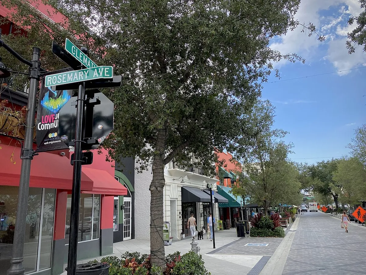 Shops and trees along Clematis Street at the corner of Rosemary Avenue in West Palm Beach