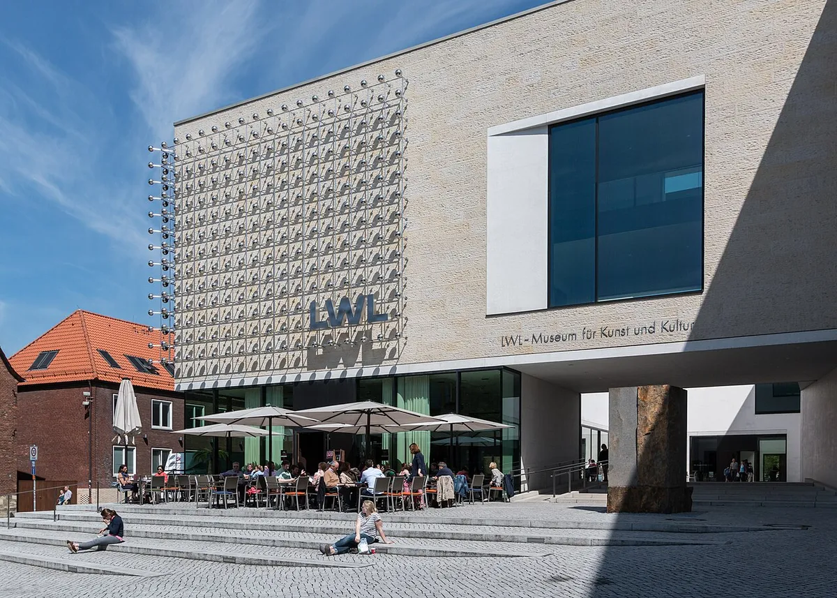 The modern stone-clad LWL-Museum für Kunst und Kultur with a shimmering metal installation on its facade