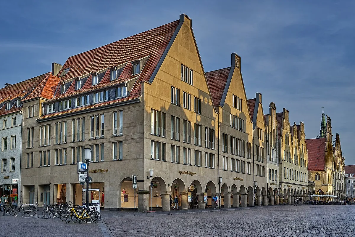 The gabled sandstone merchant houses and arcades of Münster's Prinzipalmarkt in evening light